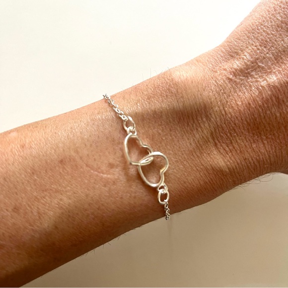 Silver Tone and Costume Jewelry Bracelet with Interlocking Hearts - Picture 1 of 3